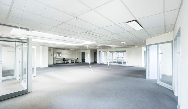 Plateau de bureaux vide et lumineux, faux plafond et luminaires encastrés, cloisons vitrées