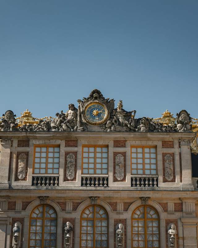 La façade de la cour de Marbre du château de Versailles, avec son horloge et ses ornements dorés