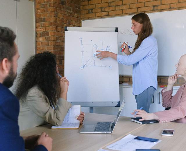 Formatrice au paperboard devant des participants attentifs